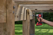 Photo of Craftsman CMCF830D2 cordless impact driver drilling into wooden beams outdoors.