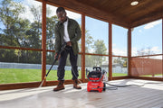 Photo of a person using a Craftsman pressure washer CMCPW1500N2 to clean an outdoor wooden deck.