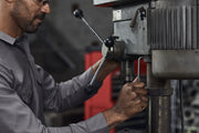 Photo of CRAFTSMAN hex key CMHT26159V used to loosen bolt on metal engine part in workshop setting.