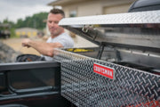 Photo of CRAFTSMAN CMXTBAK1000901 truck bed tool box with diamond plate pattern, lid open in pickup truck bed.